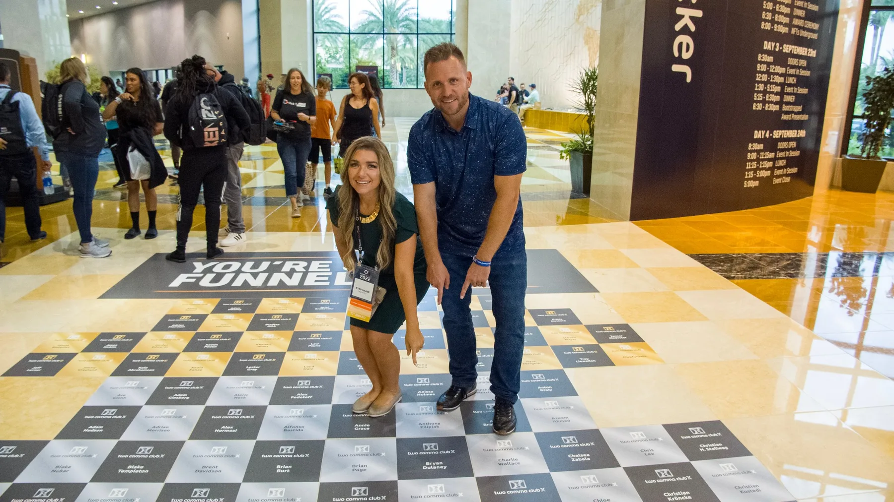 Bryan and Stephanie Dulaney pointing to their names on the floor at Funnel Hacking Live